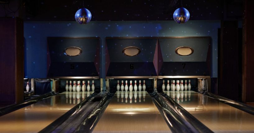 This Getty stock image shows a lit up bowling alley.