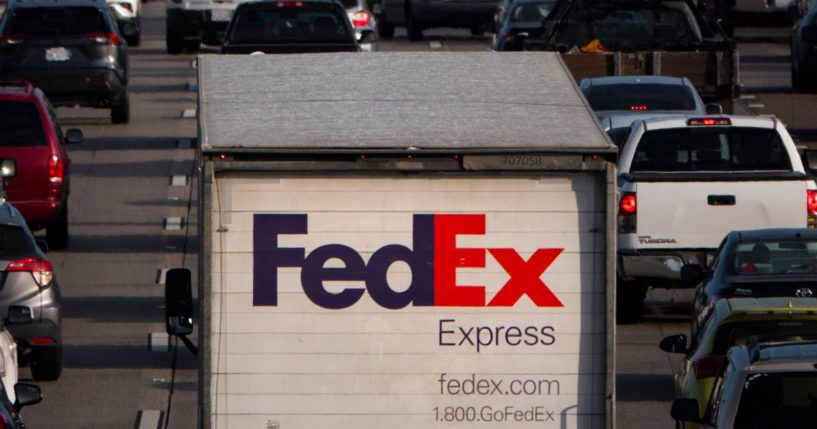 A FedEx tractor trailer sits in traffic on southbound Interstate 5 during the afternoon commute on March 12, 2024 in San Diego, California.