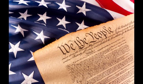 This Getty stock image shows a copy of the U.S. Constitution on the American flag.