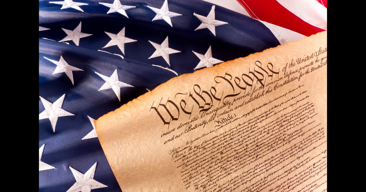 This Getty stock image shows a copy of the U.S. Constitution on the American flag.