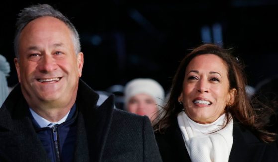 Vice President Kamala Harris (C) and Second Gentleman Douglas Emhoff (L) attend the 102nd National Christmas Tree Lighting Ceremony on the Ellipse on December 5, 2024 in Washington, DC.