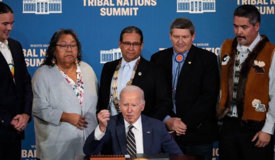 U.S. President Joe Biden signs an executive order at the 2023 White House Tribal Nations Summit at the U.S. Department of Interior on December 6, 2023 in Washington, DC.