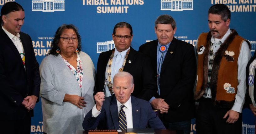 U.S. President Joe Biden signs an executive order at the 2023 White House Tribal Nations Summit at the U.S. Department of Interior on December 6, 2023 in Washington, DC.