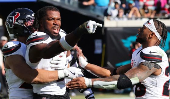 Azeez Al-Shaair #0 of the Houston Texans points to the Jacksonville Jaguars bench after a fight and being ejected during the second quarter of a game at EverBank Stadium on December 1, 2024 in Jacksonville, Florida.