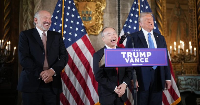 SoftBank CEO Masayoshi Son delivers remarks alongside U.S. President-elect Donald Trump and Trump's choice for Secretary of Commerce, Cantor Fitzgerald Chairman and CEO Howard Lutnick (L) at Trump’s Mar-a-Lago resort on December 16, 2024 in Palm Beach, Florida.