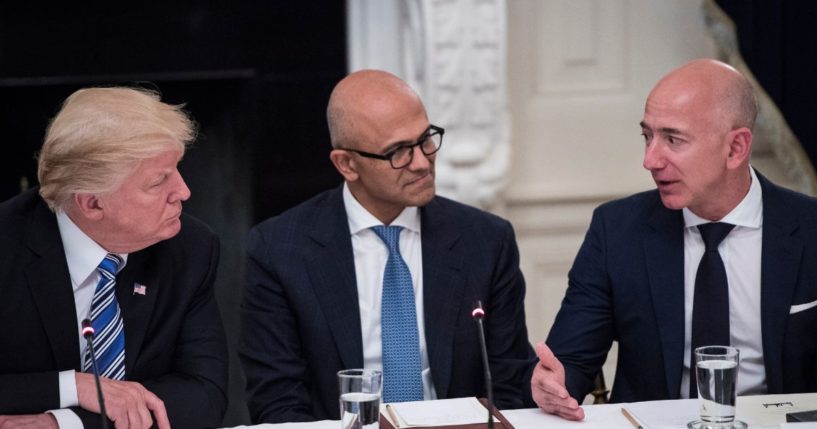 President Donald Trump speaks with Satya Nadella, Chief Executive Officer of Microsoft, and Jeff Bezos, Chief Executive Officer of Amazon during an American Technology Council roundtable in the State Dinning Room at the White House in Washington, DC on Monday, June 19, 2017.