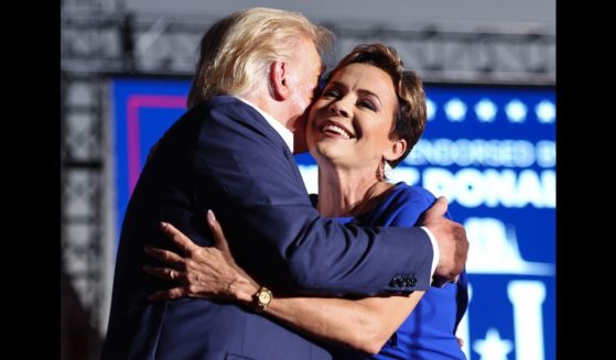 U.S. President-elect Donald Trump embraces Arizona Republican gubernatorial nominee Kari Lake at a campaign rally at Legacy Sports USA on October 9, 2022 in Mesa, Arizona.