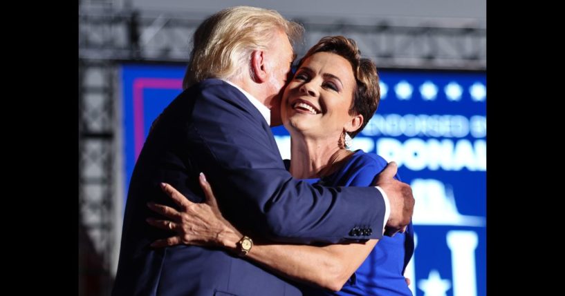 U.S. President-elect Donald Trump embraces Arizona Republican gubernatorial nominee Kari Lake at a campaign rally at Legacy Sports USA on October 9, 2022 in Mesa, Arizona.