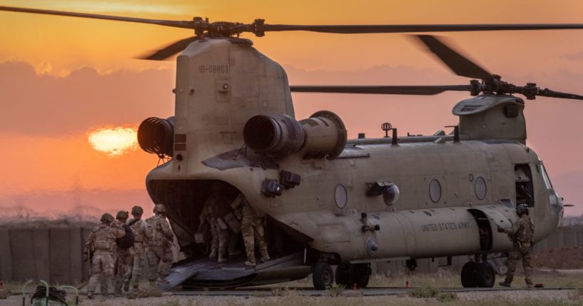 U.S. Army soldiers board a CH-47 Chinook helicopter while departing a remote combat outpost known as RLZ on May 25, 2021 near the Turkish border in northeastern Syria.