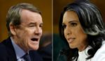 Democratic Sen. Michael Bennet of Colorado, left, questions Tulsi Gabbard, President Donald Trump’s nominee to be Director of National Intelligence, as she testifies during her confirmation hearing before the Senate Intelligence Committee Thursday in Washington, D.C.