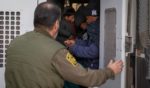 Immigrants prepare to be transported by the U.S. Border Patrol after crossing the U.S.-Mexico border Monday near Sasabe, Arizona. Immigrant families had passed through a gap in the Trump-built border wall hours before Donald J. Trump was inaugurated for a second time as President of the United States.