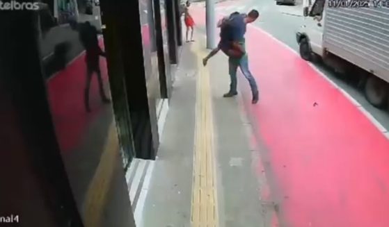 An alleged Brazilian jewel thief is thrown to the ground by a passerby.