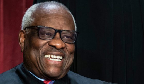 Supreme Court Justice Clarence Thomas waits to take a group photo with other justices at the Supreme Court building on Capitol Hill in Washington, D.C., on Oct. 7, 2022.