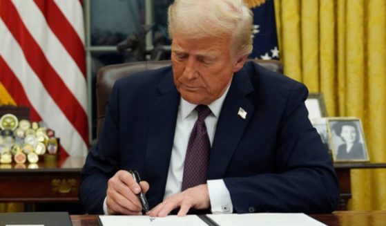 President Donald Trump signs an executive order to create the Department of Government Efficiency in the Oval Office of the White House in Washington, D.C., on Jan. 20.