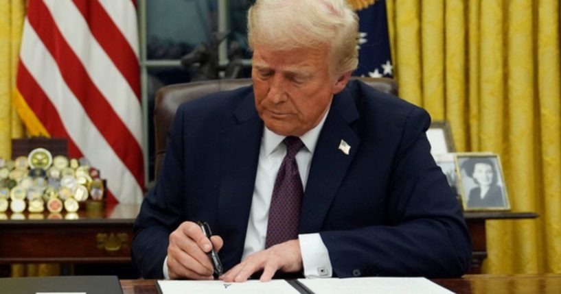 President Donald Trump signs an executive order to create the Department of Government Efficiency in the Oval Office of the White House in Washington, D.C., on Jan. 20.