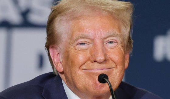 Then Republican presidential candidate Donald Trump smiles during a Hispanic roundtable in Las Vegas, Nevada, on Oct. 12.