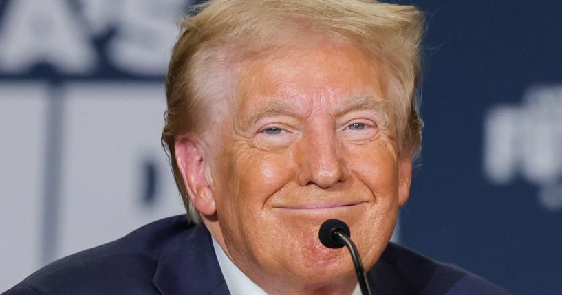 Then Republican presidential candidate Donald Trump smiles during a Hispanic roundtable in Las Vegas, Nevada, on Oct. 12.