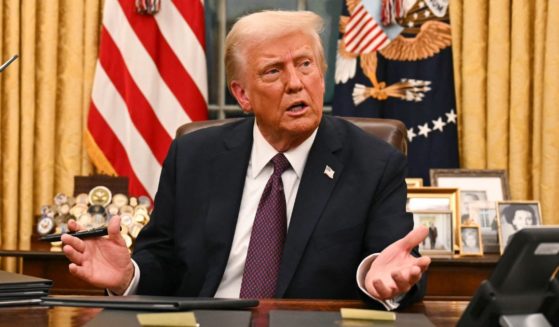 President Donald Trump signs a series of executive orders in the Oval Office of the White House in Washington, D.C., on Monday.