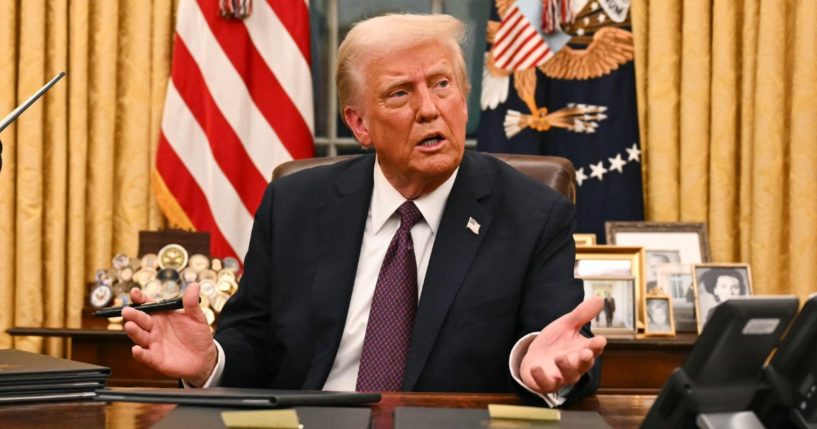 President Donald Trump signs a series of executive orders in the Oval Office of the White House in Washington, D.C., on Monday.