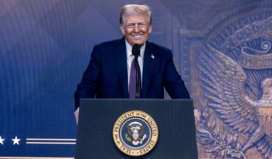 President Donald Trump is seen on a giant screen during his address by video conference at the World Economic Forum annual meeting in Davos on Thursday.