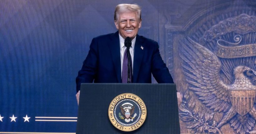 President Donald Trump is seen on a giant screen during his address by video conference at the World Economic Forum annual meeting in Davos on Thursday.