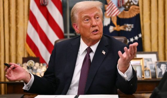 President Donald Trump signs an executive order in the Oval Office of the White House in Washington, D.C., on Jan. 20.