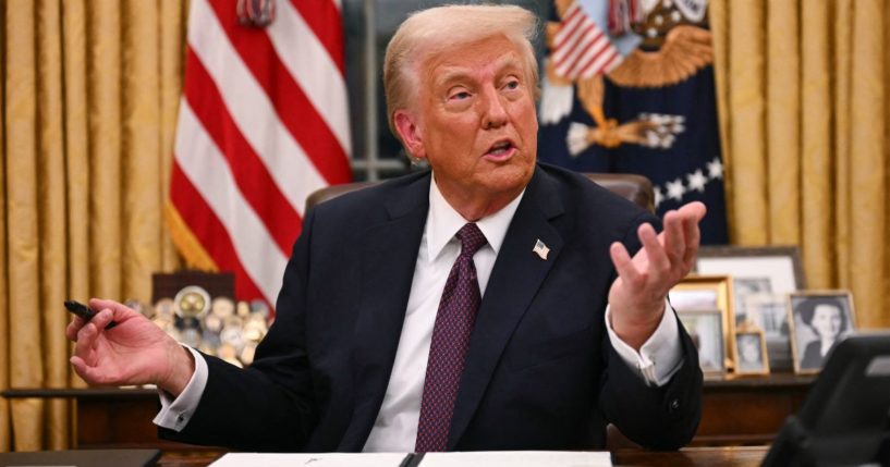 President Donald Trump signs an executive order in the Oval Office of the White House in Washington, D.C., on Jan. 20.