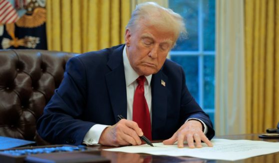 President Donald Trump signs an executive order to appoint Chris Rocheleau as the Deputy Administrator of the Federal Aviation Administration in the Oval Office at the White House in Washington, D.C., on Thursday.