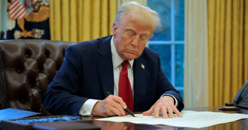 President Donald Trump signs an executive order to appoint Chris Rocheleau as the Deputy Administrator of the Federal Aviation Administration in the Oval Office at the White House in Washington, D.C., on Thursday.