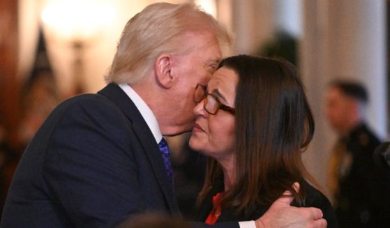 President Donald Trump, left, embraces Allyson Phillips, mother of Laken Riley, right, before signing the Laken Riley Act in the East Room of the White House in Washington, D.C., on Wednesday.