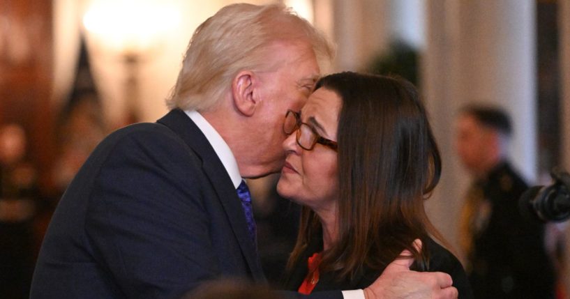 President Donald Trump, left, embraces Allyson Phillips, mother of Laken Riley, right, before signing the Laken Riley Act in the East Room of the White House in Washington, D.C., on Wednesday.