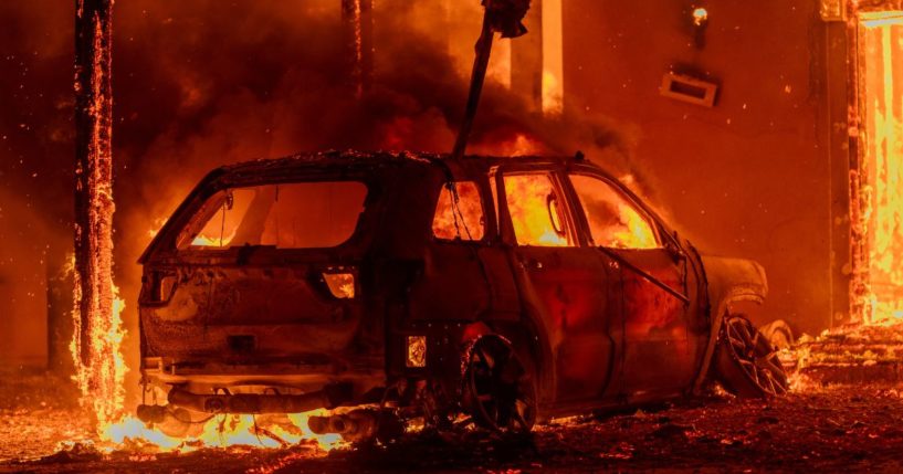 A car and house burn in the Eaton Fire in Altadena, California, on Wednesday.