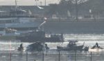 Part of the wreckage is seen on Thursday morning as rescue crews search the waters of the Potomac River after a passenger plane collided with a Black Hawk helicopter on approach to Reagan National Airport on Wednesday night.