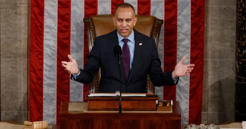 Rep. Hakeem Jeffries peaks on the first day of the 119th Congress in the House Chamber of the U.S. Capitol Building in Washington, D.C., on Friday.