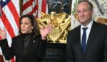 Then-Vice President Kamala Harris, left, with then-second gentleman Doug Emhoff, right, speaks before signing the drawer of her desk during a signing ceremony in the Vice President's Ceremonial Office at the White House on Jan. 16.