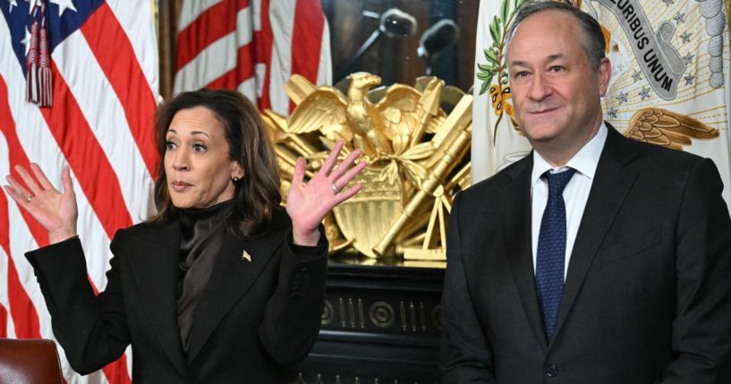 Then-Vice President Kamala Harris, left, with then-second gentleman Doug Emhoff, right, speaks before signing the drawer of her desk during a signing ceremony in the Vice President's Ceremonial Office at the White House on Jan. 16.