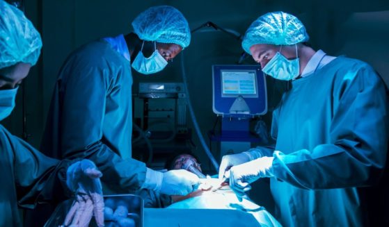 A team of surgeons perform a heart transplant operation for a patient.