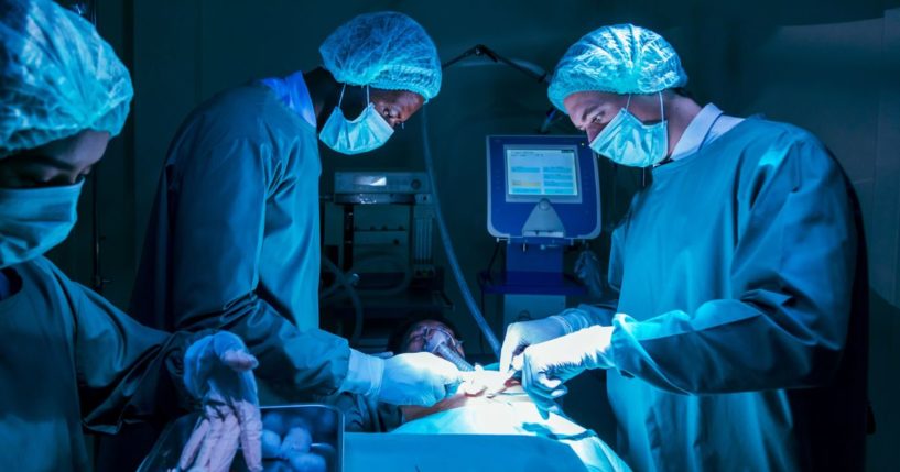 A team of surgeons perform a heart transplant operation for a patient.