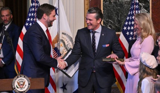 Defense Secretary Pete Hegseth shakes hands with Vice President J.D. Vance as he is surrounded by his wife Jennifer and his seven children after being sworn in as the new Secretary of Defense at the Eisenhower Executive Office Building at the White House in Washington, D.C., on January 25, 2025.