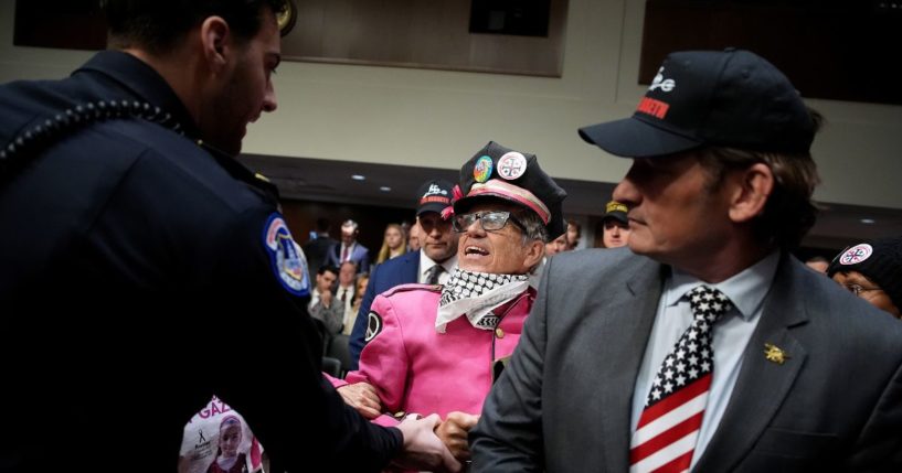 Protesters with the group CodePink demonstrate at the start of the Senate Armed Services confirmation hearing Tuesday for President-elect Donald Trump's nominee for Secretary of Defense Pete Hegseth on Capitol Hill in Washington, D.C.