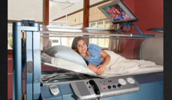 An unidentified woman appears in a promotional video for the facility's hyperbaric oxygen treatment.