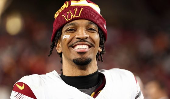 Jayden Daniels of the Washington Commanders smiles after an NFL football wild card playoff game against the Tampa Bay Buccaneers in Tampa, Florida, on Sunday.