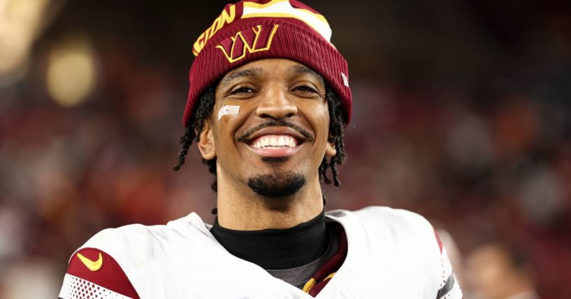 Jayden Daniels of the Washington Commanders smiles after an NFL football wild card playoff game against the Tampa Bay Buccaneers in Tampa, Florida, on Sunday.