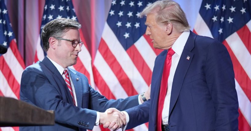 Speaker of the House Mike Johnson and President-elect Donald Trump shake hands onstage at a House Republicans Conference meeting in Washington, D.C., on Nov. 13.