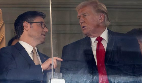 Speaker of the House Mike Johnson, left, speaks with President-elect Donald Trump, right, at the 125th Army-Navy football game at in Landover, Maryland, on Dec. 14.