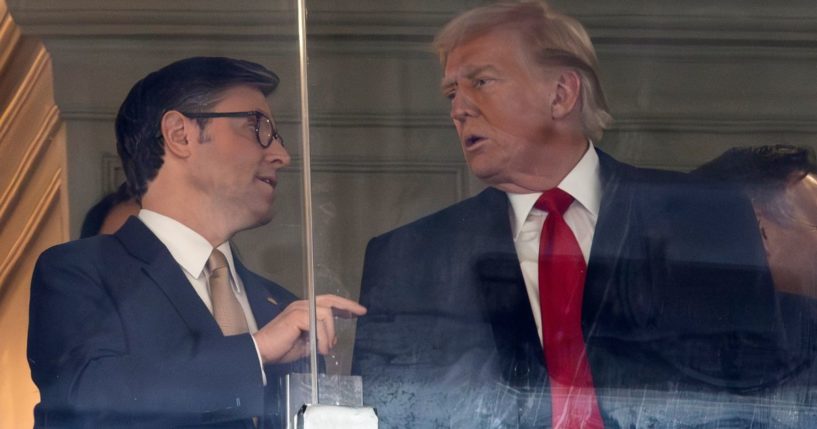 Speaker of the House Mike Johnson, left, speaks with President-elect Donald Trump, right, at the 125th Army-Navy football game at in Landover, Maryland, on Dec. 14.