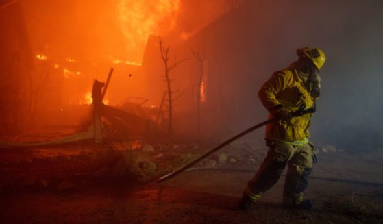 A firefighter battles flames from the Palisades Fire in Los Angeles, California, on Tuesday.