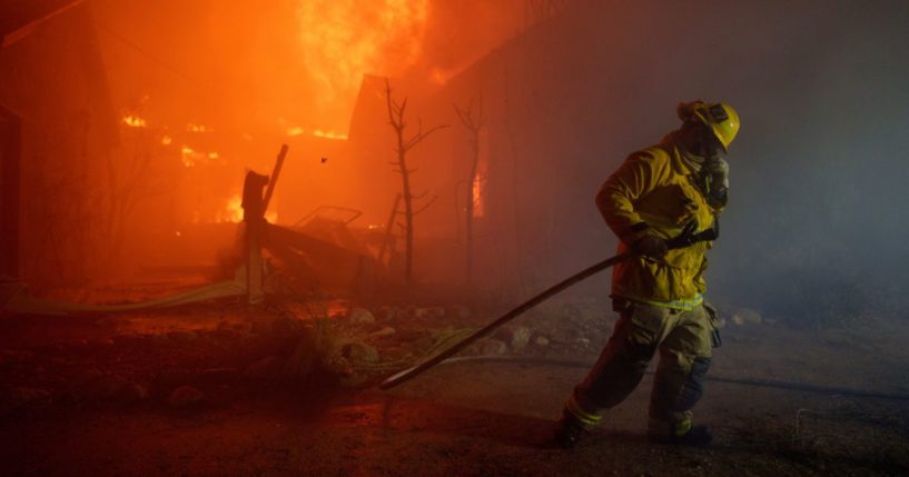 A firefighter battles flames from the Palisades Fire in Los Angeles, California, on Tuesday.