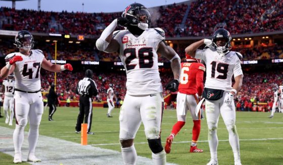 Joe Mixon, center, of the Houston Texans celebrates after scoring a touchdown against the Kansas City Chiefs during the third quarter in the AFC Divisional Playoff in Kansas City, Missouri, on Saturday.