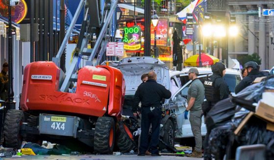 Police investigators surround a white truck that drove into the New Year's Eve festivities on Bourbon Street in the French Quarter of New Orleans, Louisiana, on Wednesday.